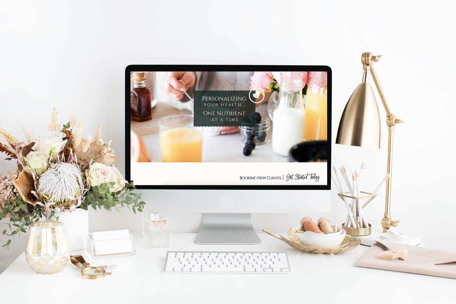 Thrive Nutrition website on a desktop computer on a styled desk